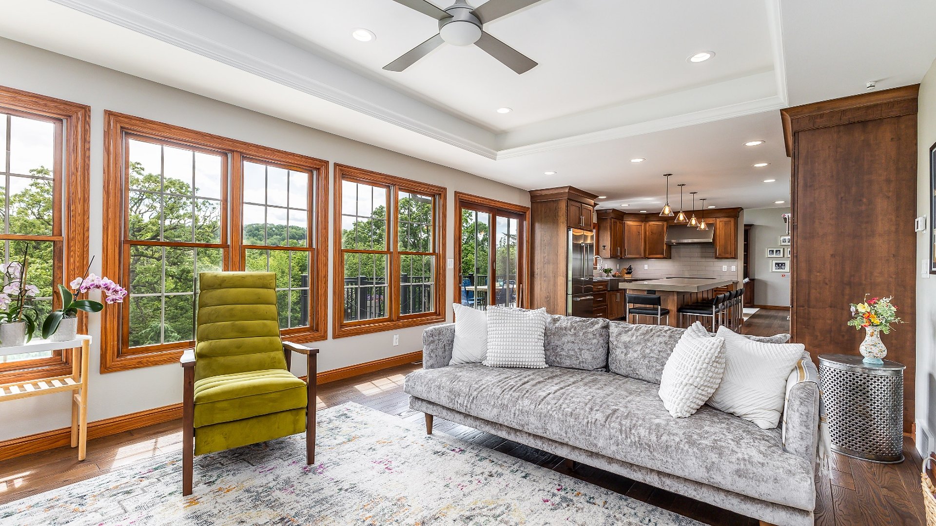 Open concept living room with floor-to-ceiling windows and kitchen — Kemp Court home sold by Deb Hooks